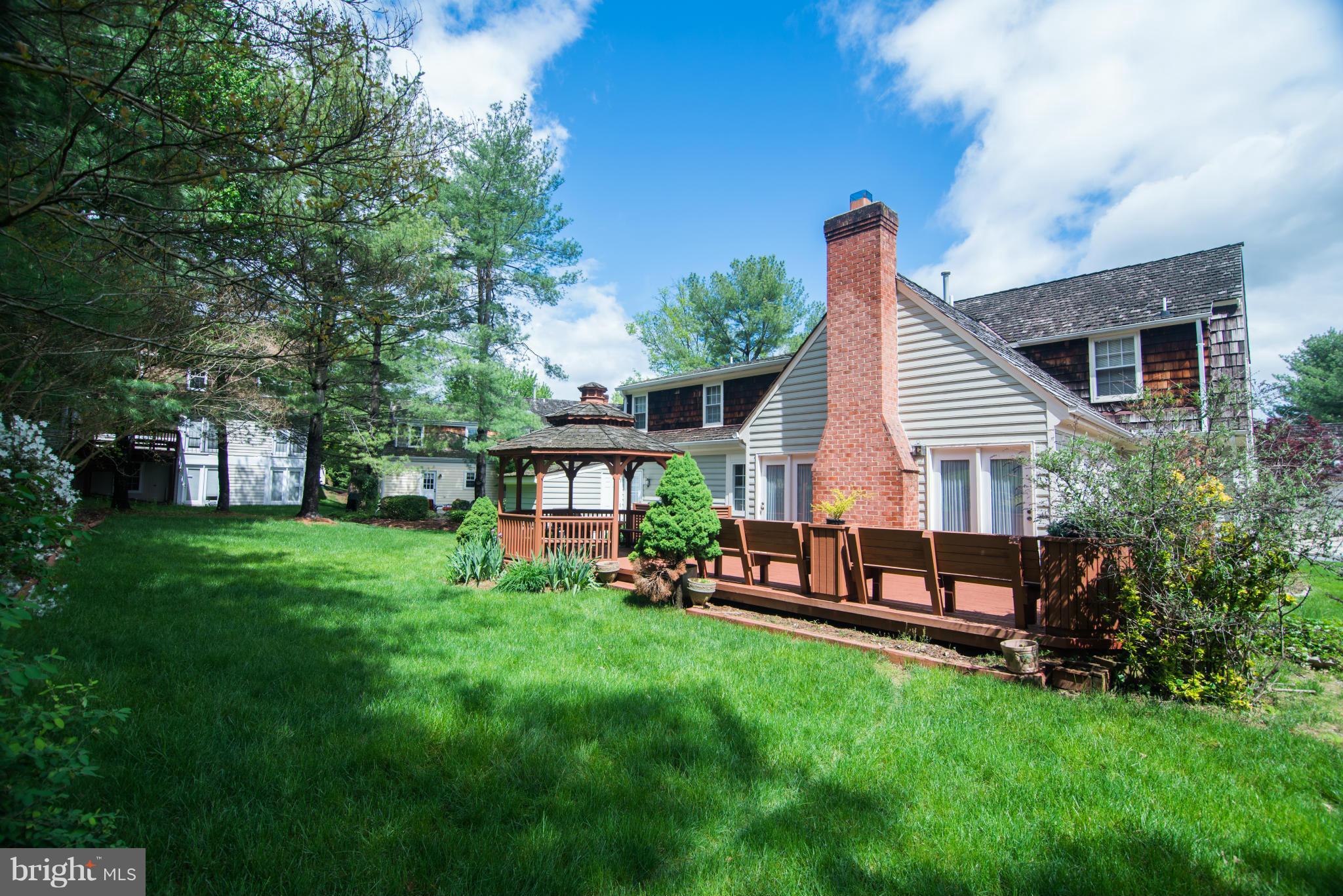 4 Midsummer Court Gaithersburg, MD 20878 - Photo 21 of 24 a view of a house with a backyard and chairs