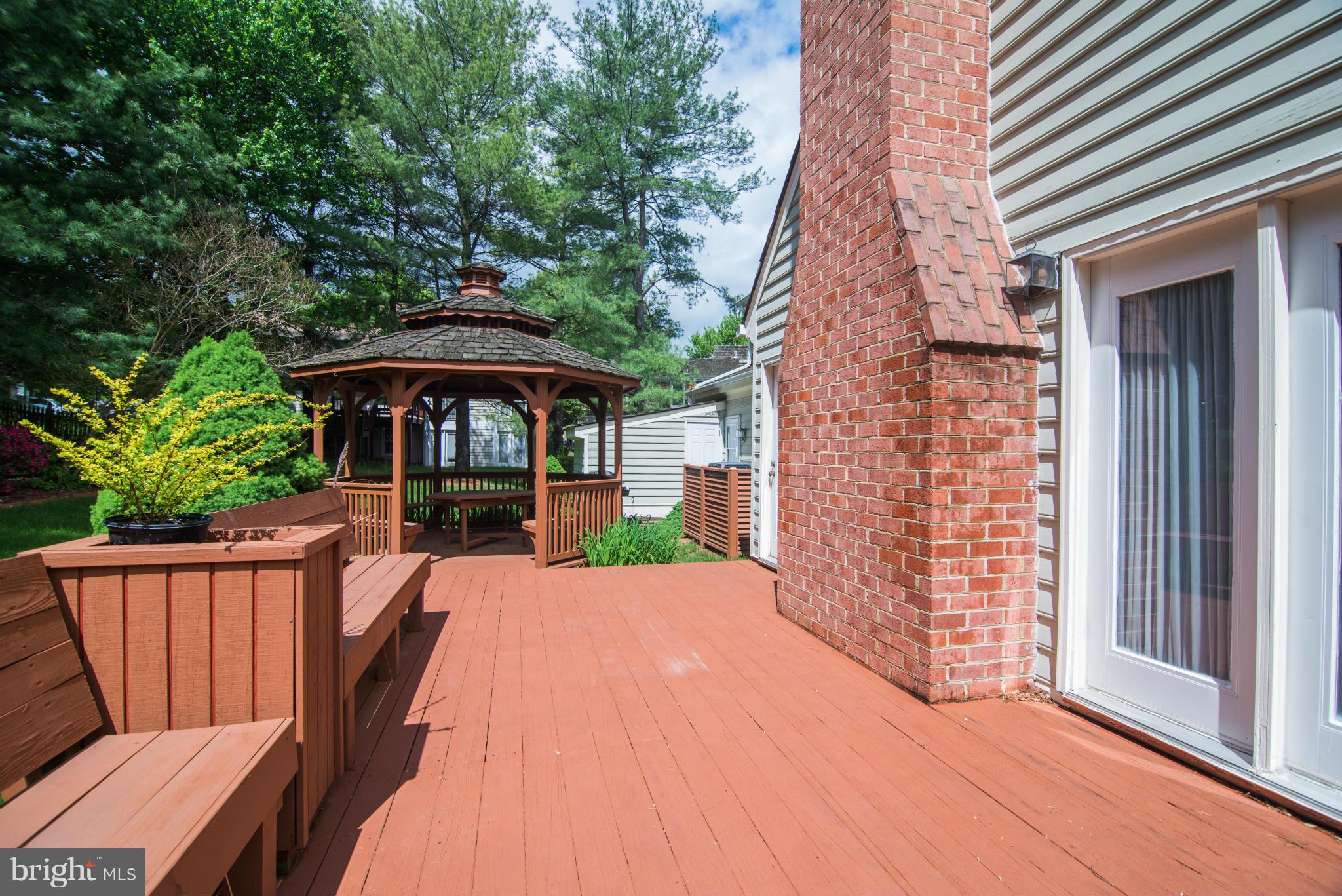 4 Midsummer Court Gaithersburg, MD 20878 - Photo 23 of 24 a view of a patio with a table and chairs under an umbrella with wooden fence