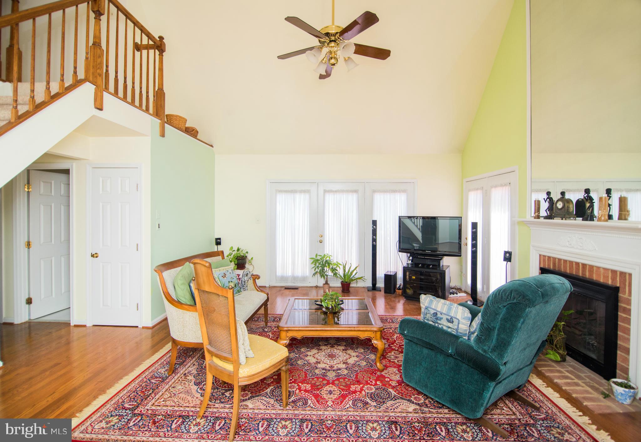 4 Midsummer Court Gaithersburg, MD 20878 - Photo 4 of 24 a living room with furniture and a fireplace