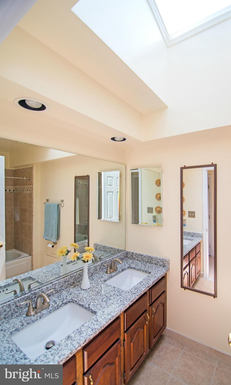 4 Midsummer Court Gaithersburg, MD 20878 - Photo 6 of 24 a bathroom with a granite countertop sink and a large mirror