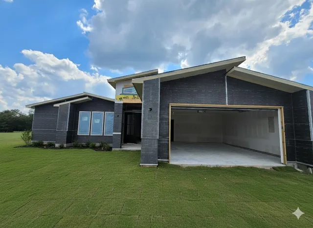 a view of an house with backyard space and garage