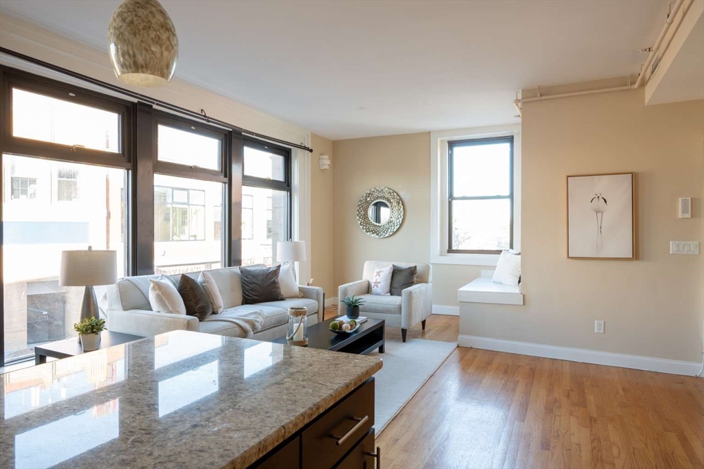 191 Main Street, Unit 2A Gloucester, MA 01930 - Photo 4 of 15 a living room with furniture and a large window
