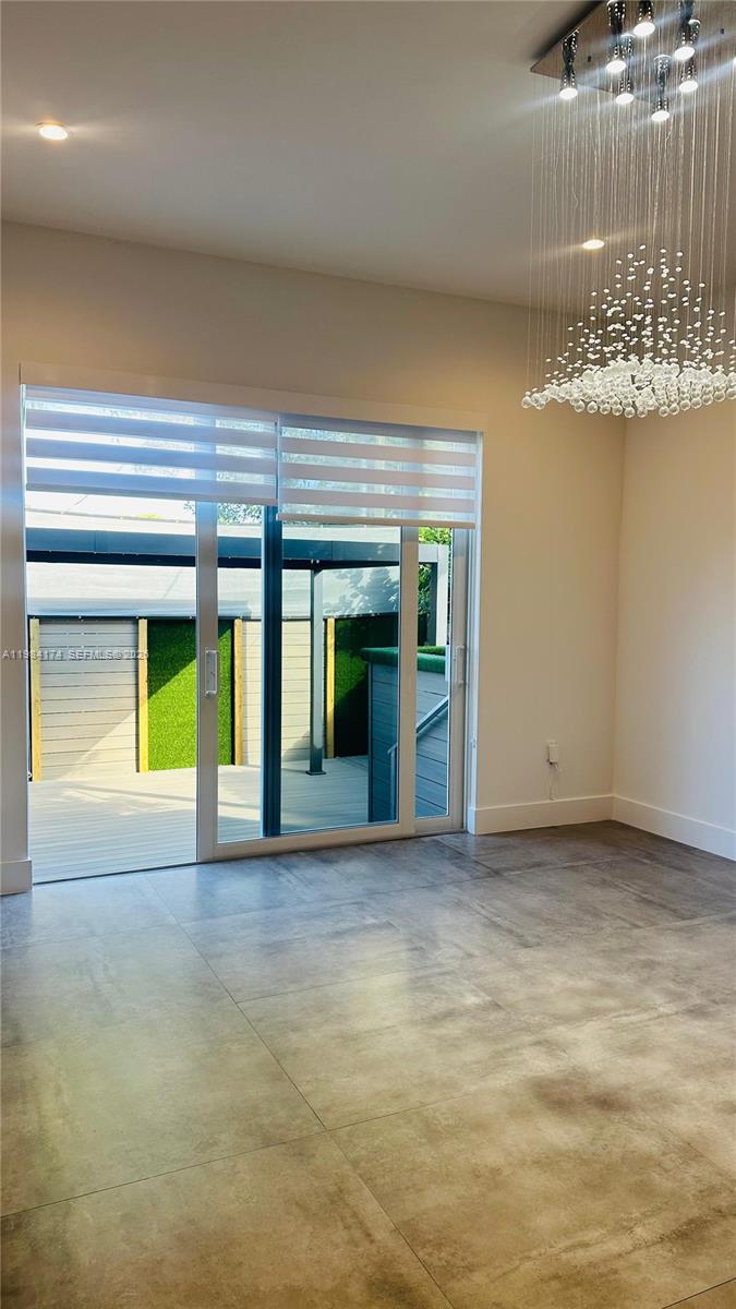 3653 Southwest 25th Street, Unit 3653 Miami, FL 33133 - Photo 18 of 18 a view of an empty room with a fireplace