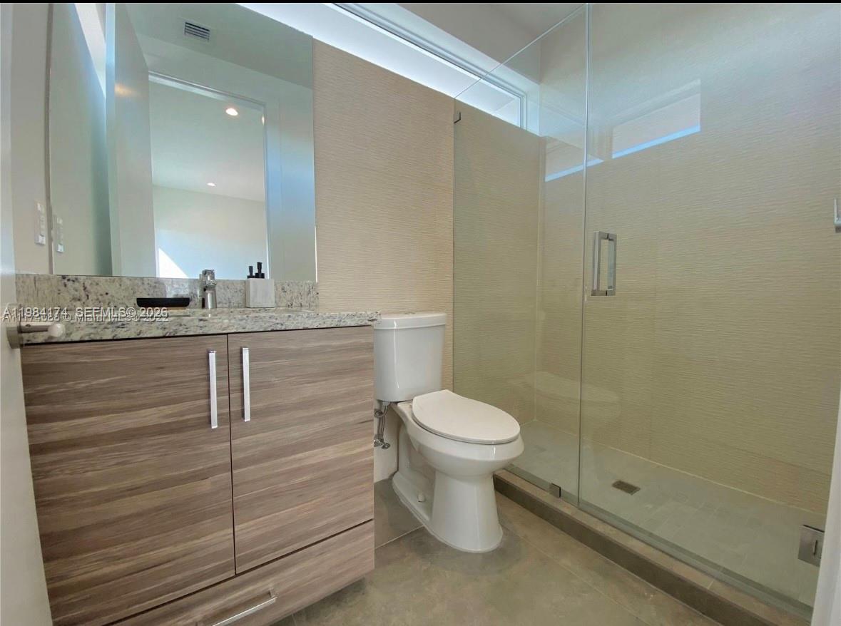 3653 Southwest 25th Street, Unit 3653 Miami, FL 33133 - Photo 7 of 18 a bathroom with a granite countertop sink toilet and shower