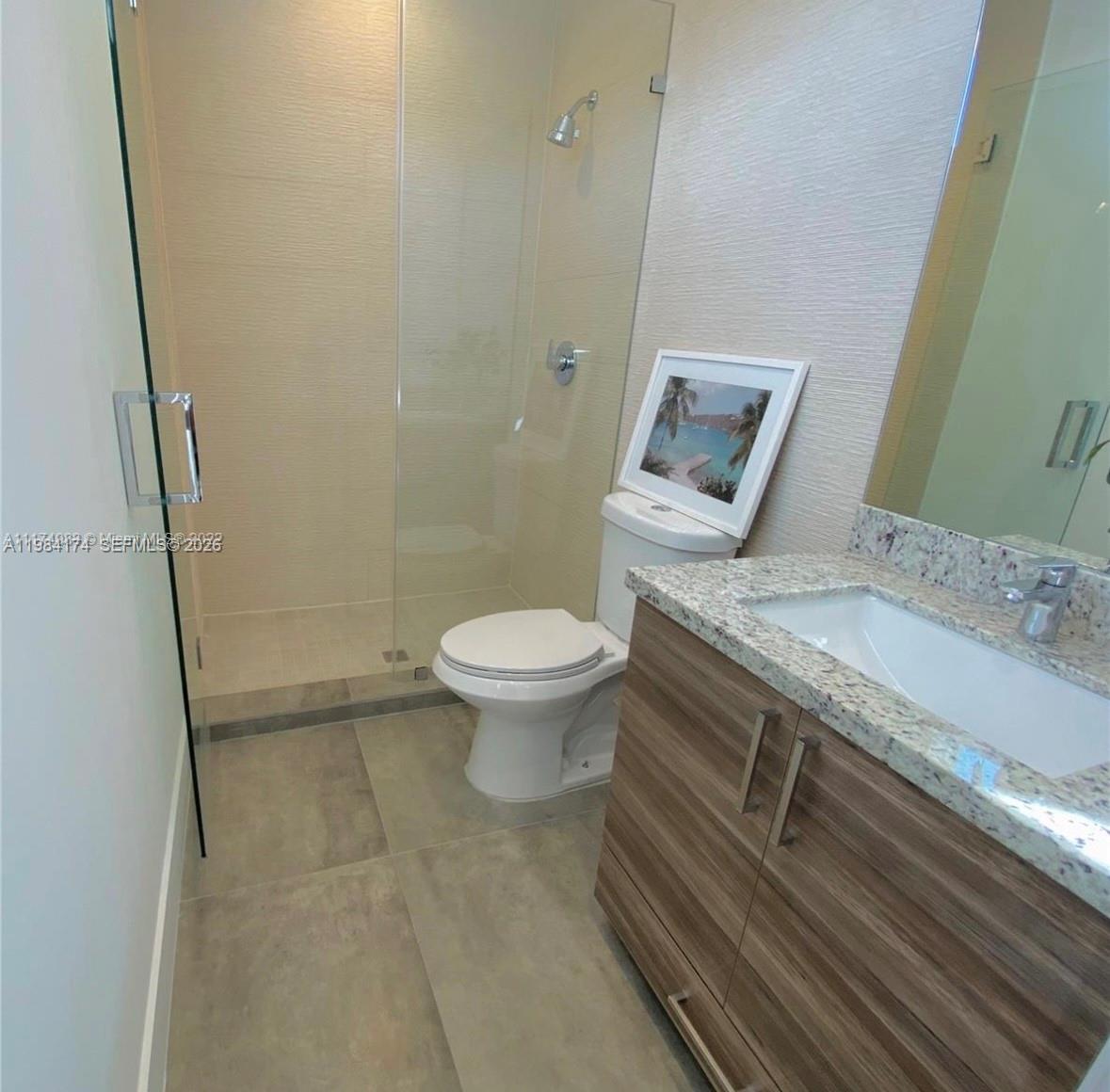 3653 Southwest 25th Street, Unit 3653 Miami, FL 33133 - Photo 9 of 18 a bathroom with a granite countertop sink toilet and shower