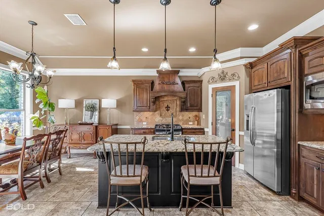 a view of a dining room with furniture kitchen and chandelier