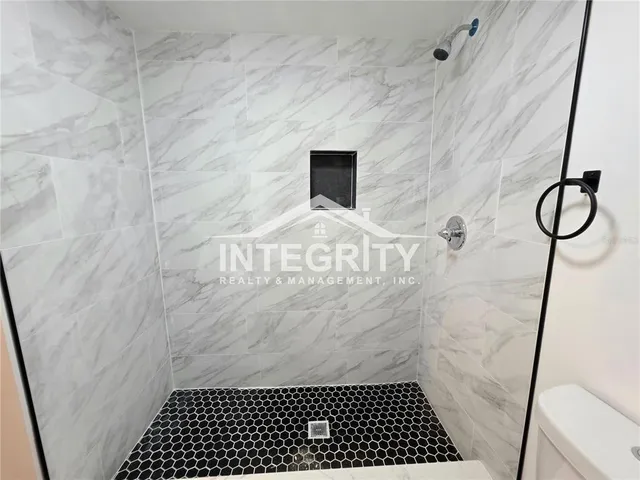 a view of a livingroom with wooden floor and a window