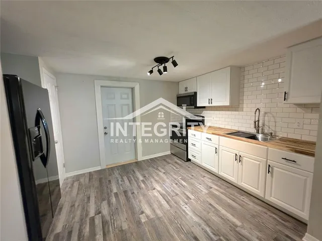 a kitchen with stainless steel appliances granite countertop a sink stove and microwave