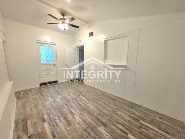 a view of a room with wooden floor