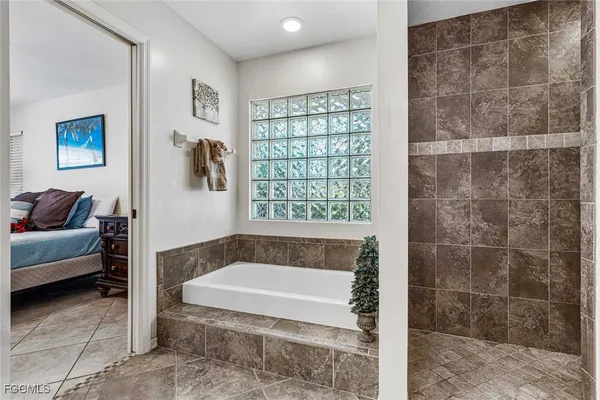 a bathroom with a tub and a shower