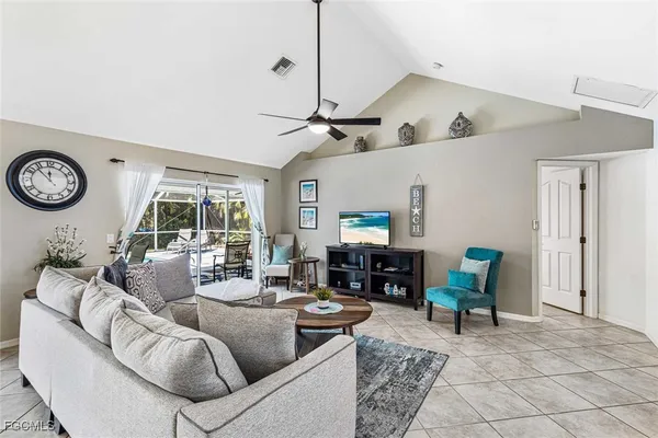 a living room with furniture a fireplace and a window