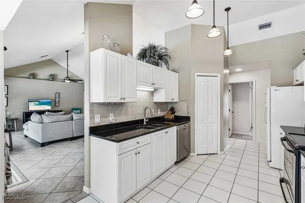 a kitchen with a sink a counter and cabinets
