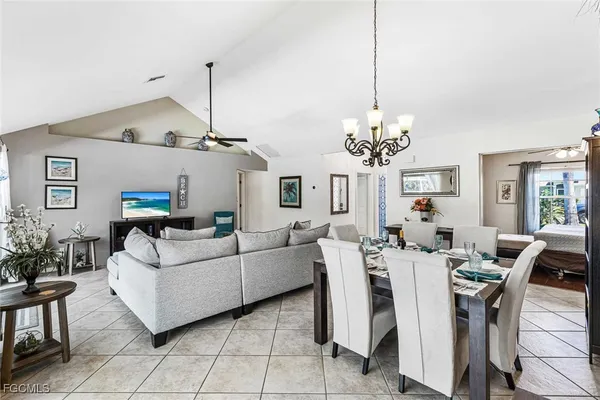 a living room with furniture a chandelier and a chandelier