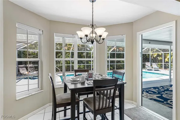 a view of a dining room with furniture large windows and wooden floor