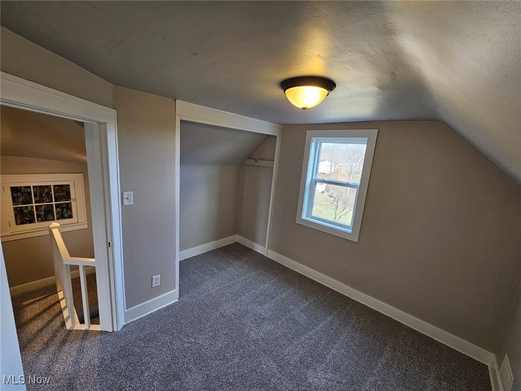 5961 State Rte 213 Toronto, OH 43964 - Photo 14 of 15 Bonus room featuring dark colored carpet, a textured ceiling, and lofted ceiling