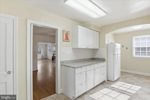 a kitchen with a stove a sink and a refrigerator