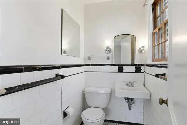 a bathroom with a toilet sink and mirror