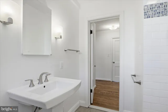 a bathroom with a sink a mirror and shower