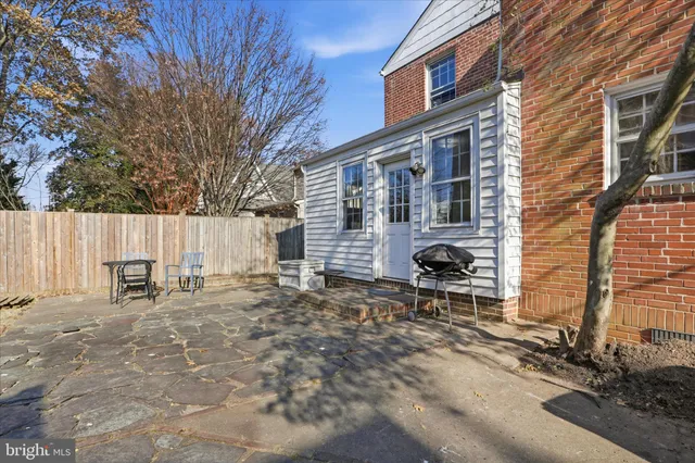a backyard of a house with table and chairs
