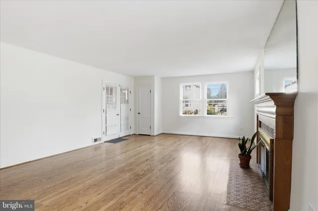 a view of a livingroom with wooden floor and a window