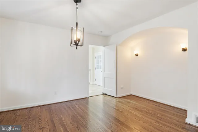 a view of a room with wooden floor closet and windows