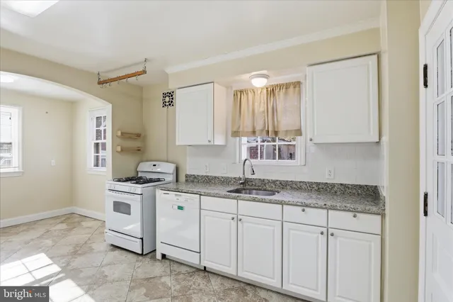 a kitchen with stainless steel appliances granite countertop a sink and a stove