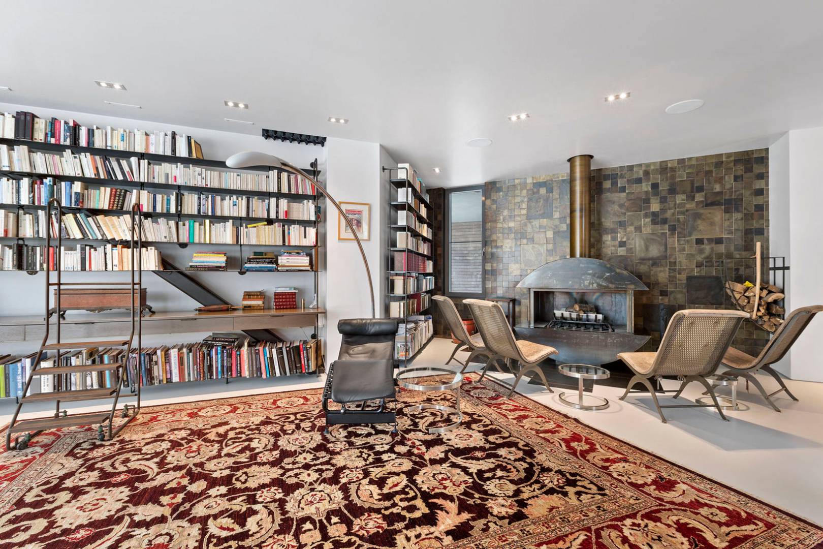 40 Sayre's Path Wainscott, NY 11975 - Photo 11 of 14 a living room with furniture a rug and a book shelf