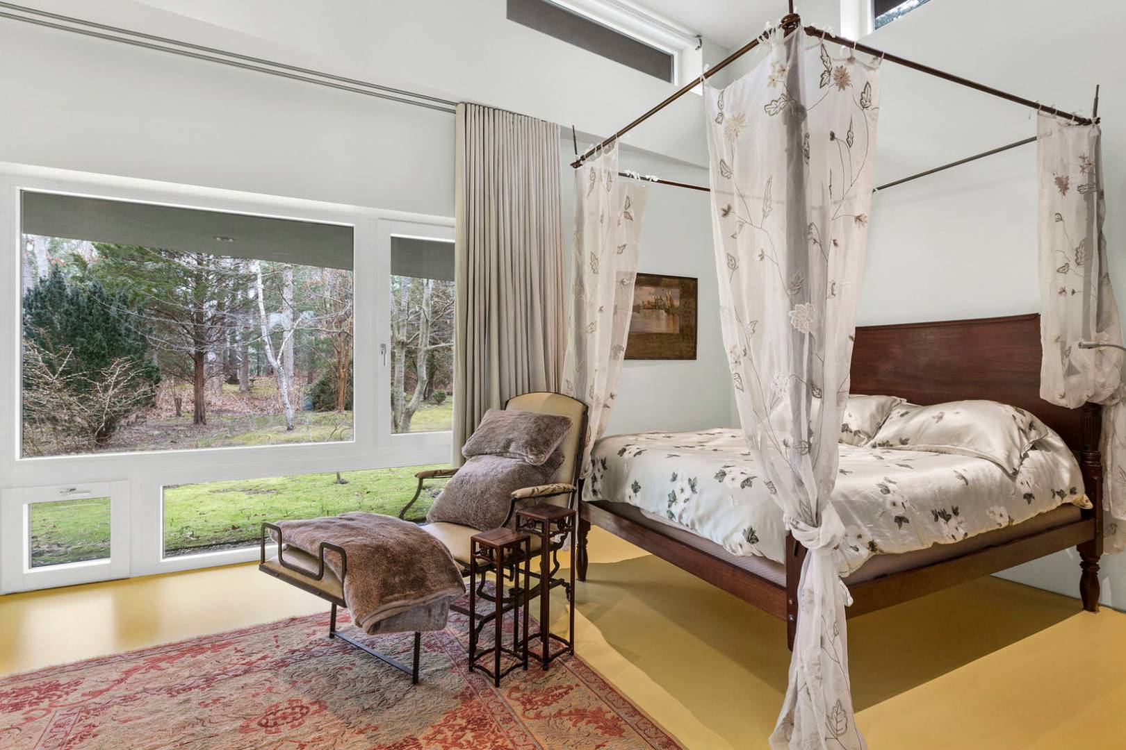 40 Sayre's Path Wainscott, NY 11975 - Photo 3 of 14 a bed sitting in a bedroom next to a window