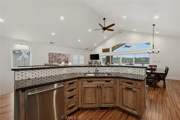 a kitchen with stainless steel appliances granite countertop a refrigerator and a stove top oven