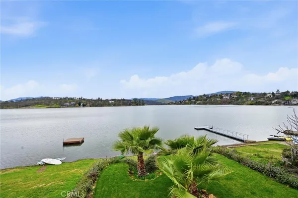a bathroom with a granite countertop toilet a sink and mirror