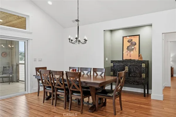 a dining room with furniture and wooden floor