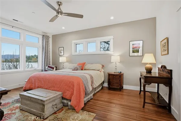 a bathroom with a tub a double vanity sink and mirror