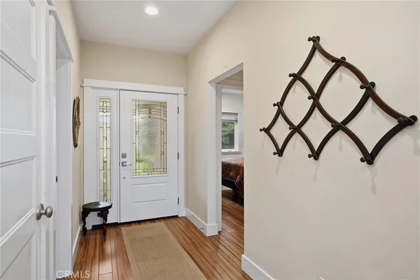 an open kitchen with wooden floor and stainless steel appliances