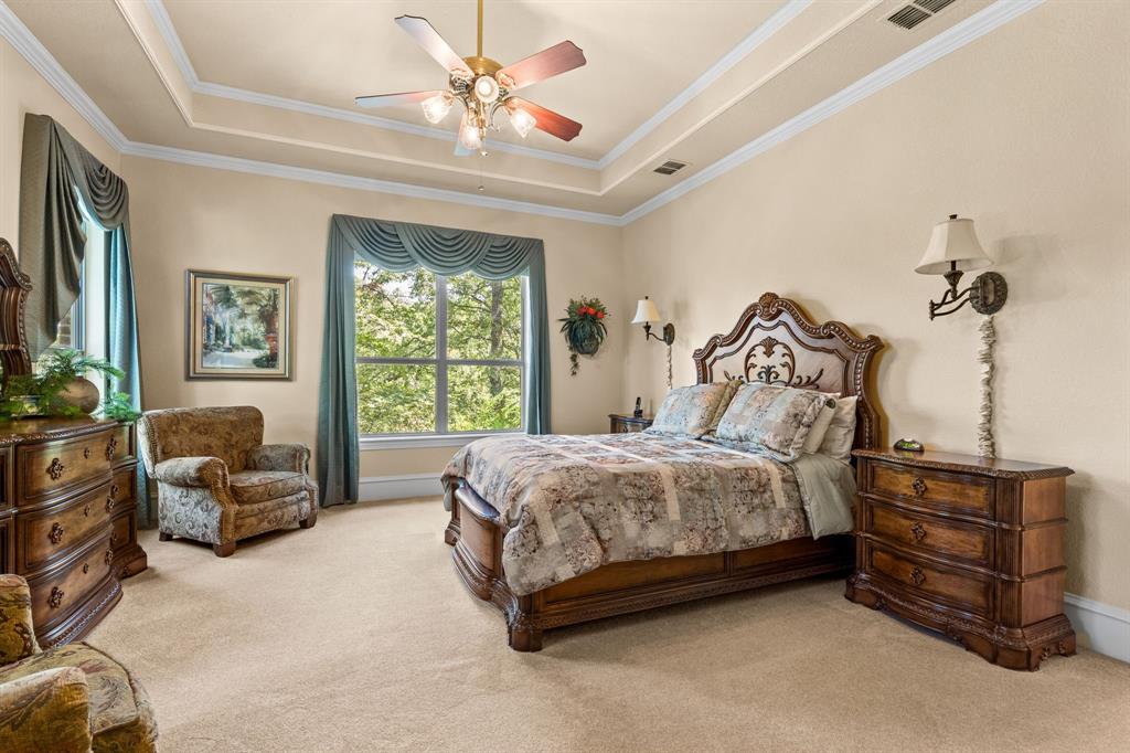 10072 Bluffview Circle Pilot Point, TX 76258 - Photo 12 of 38 Bedroom with a raised ceiling, light carpet, crown molding, and ceiling fan
