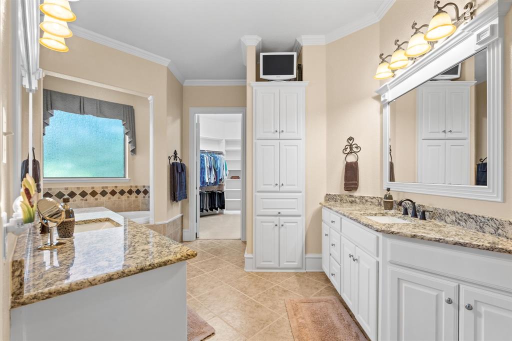 10072 Bluffview Circle Pilot Point, TX 76258 - Photo 13 of 38 Full bathroom with two vanities, ornamental molding, a spacious closet, and light tile patterned floors
