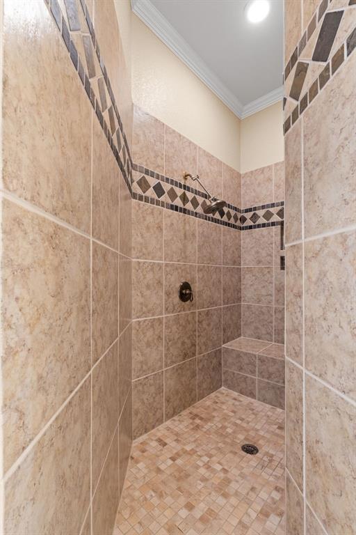 10072 Bluffview Circle Pilot Point, TX 76258 - Photo 15 of 38 Bathroom with ornamental molding and a tile shower