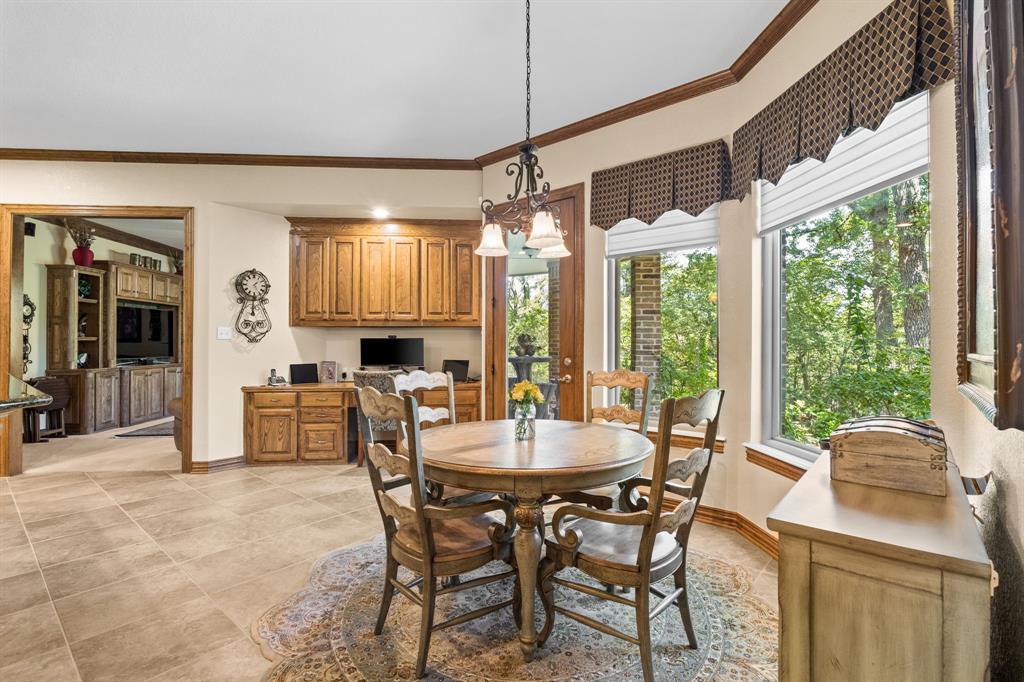 10072 Bluffview Circle Pilot Point, TX 76258 - Photo 21 of 38 Dining area with ornamental molding, plenty of natural light, a chandelier, light tile patterned floors, and a desk