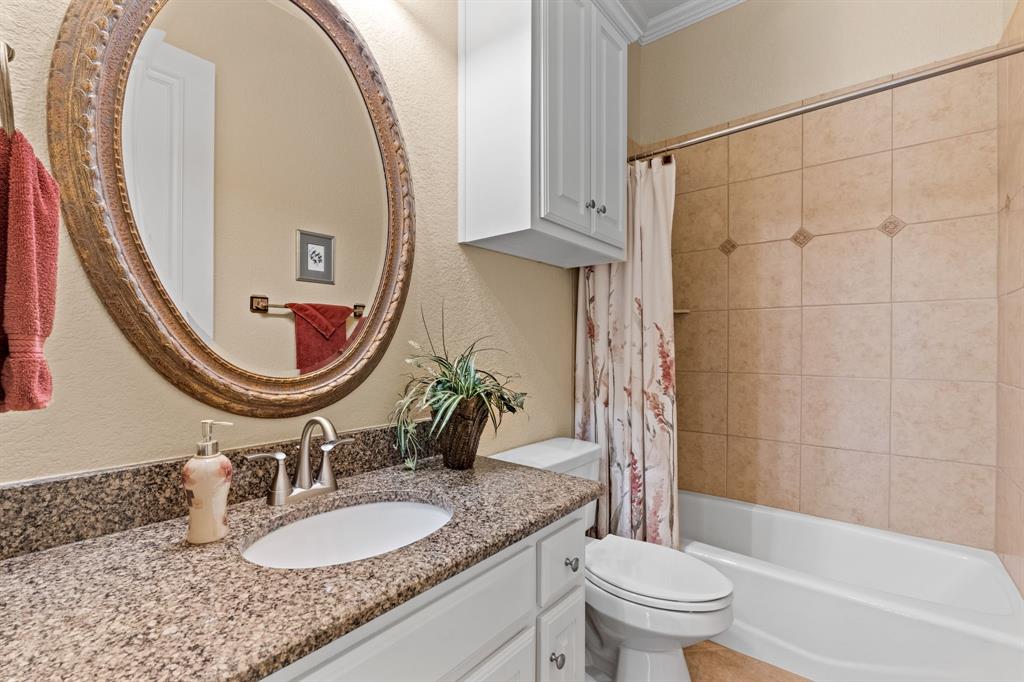 10072 Bluffview Circle Pilot Point, TX 76258 - Photo 25 of 38 Bathroom featuring shower / bath combination with curtain, vanity, a textured wall, and ornamental molding