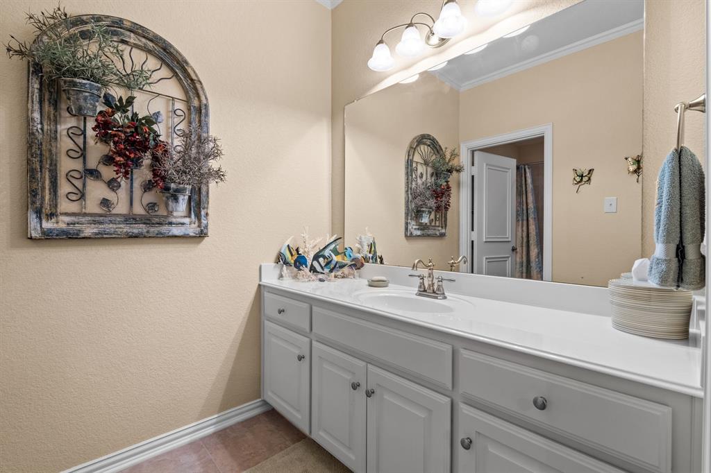 10072 Bluffview Circle Pilot Point, TX 76258 - Photo 28 of 38 Bathroom with crown molding, a textured wall, vanity, and light tile patterned flooring