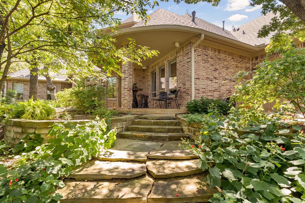 10072 Bluffview Circle Pilot Point, TX 76258 - Photo 32 of 38 Entrance to property featuring a patio area, brick siding, and a shingled roof