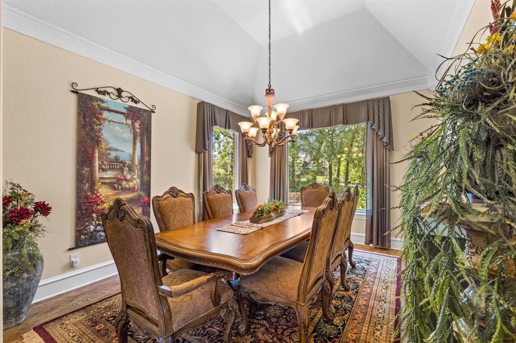 10072 Bluffview Circle Pilot Point, TX 76258 - Photo 6 of 38 Dining area featuring wood finished floors, lofted ceiling, crown molding, and a chandelier