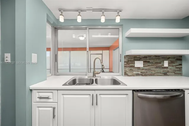 a kitchen with a sink and cabinets