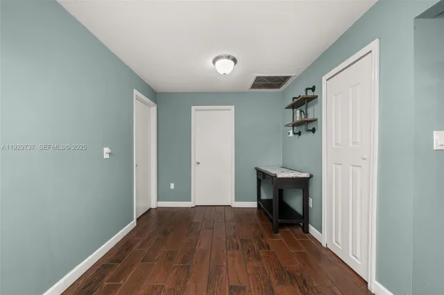 a workspace with wooden floor and a window