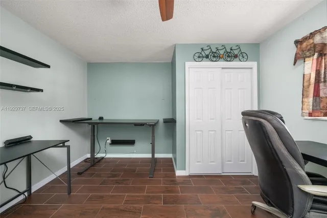 a work room with furniture and a ceiling fan