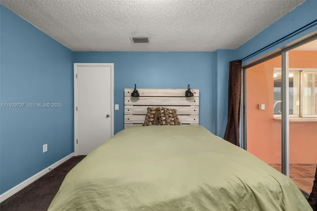 a bedroom with a bed and a lamp