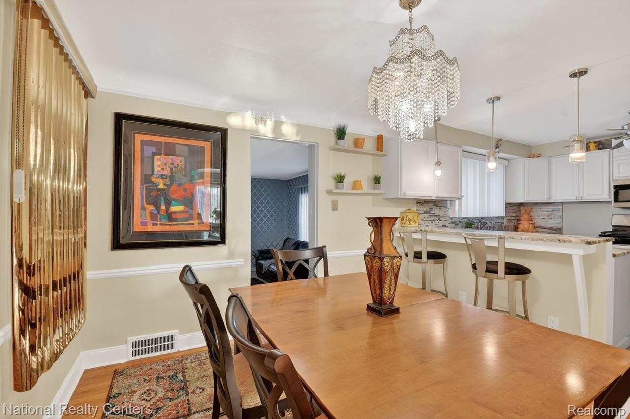 3956 Harvard Road Detroit, MI 48224 - Photo 10 of 44 Dining room with light wood finished floors and suspended lighting