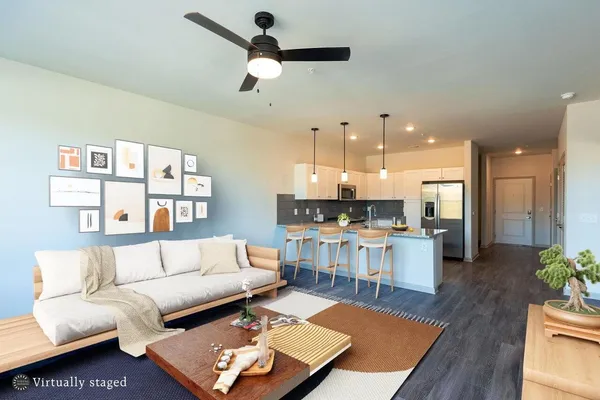 a living room with furniture and kitchen view