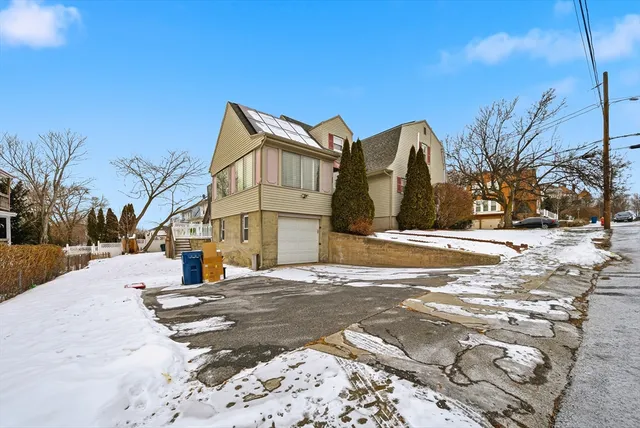a view of a house with a snow on the road