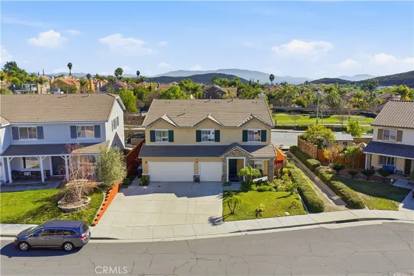 an aerial view of a house with a garden and lake view