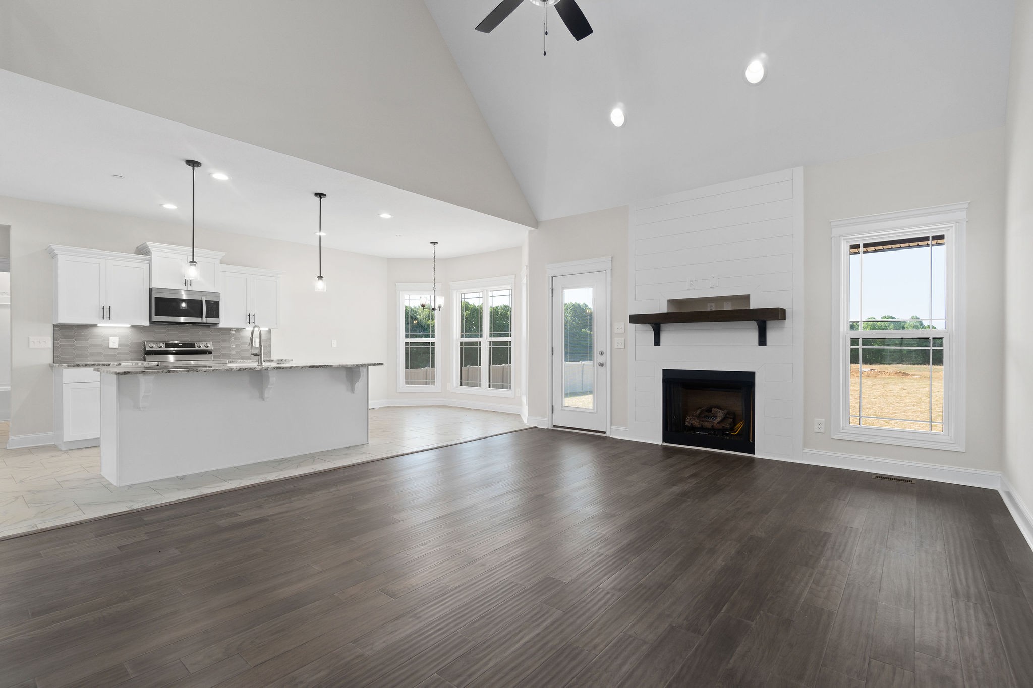6507 Blacksmith Drive Pleasant View, TN 37146 - Photo 2 of 5 a view of an empty room with wooden floor and a kitchen